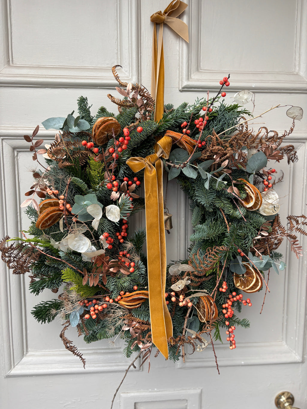 A festive seasonal door wreath. Lots of beautiful ingredients and decorated with beautiful soft velvety ribbon 