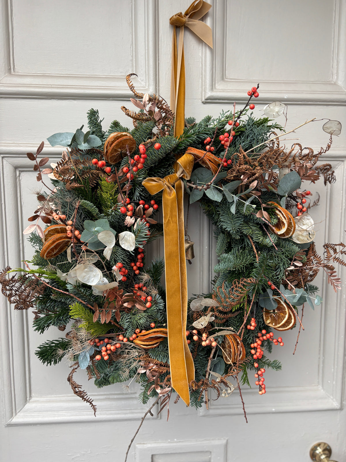 A festive seasonal door wreath. Lots of beautiful ingredients and decorated with beautiful soft velvety ribbon 